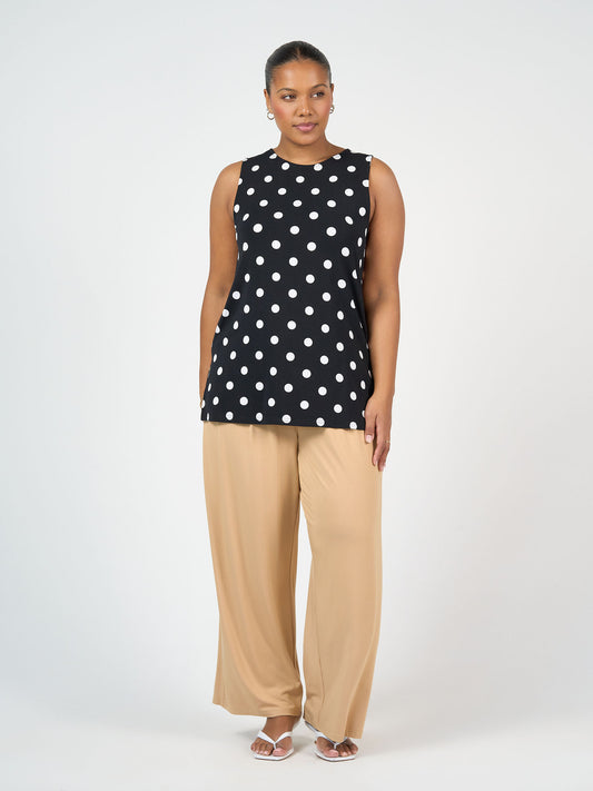 Fantasia Bamboo Tunic Top by Lou Lou Australia—a sleeveless black bamboo top with white polka dots.