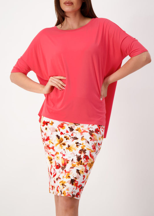 Lou Lou Australia Gina Oversized Slouch Bamboo T-Shirt in Berry, shown with a fitted, knee-length floral skirt.