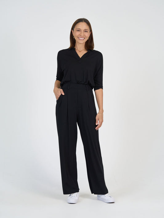 The Day Shift Set from Lou Lou Australia: black bamboo long-sleeve top and high-waisted wide leg dress pants.