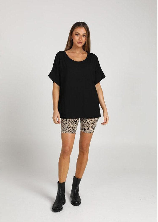 Lou Lou Australia Demi Oversized Bamboo Box T-Shirt in black, made from bamboo, paired with leopard print cycling shorts.