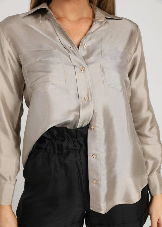 The Silk Long-sleeve Shirt by Lou Lou Australia: shiny light gray bamboo button-up with two chest pockets.