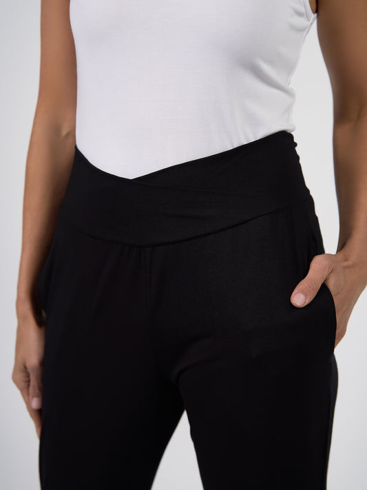 Lou Lou Australia Perry Bamboo Cropped Pants in black with a crossover waistband.