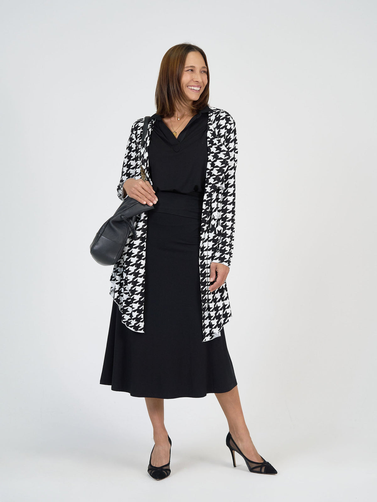 Lou Lou Australia Houndstooth Cardigan in black and white bamboo, styled over a black top and skirt.
