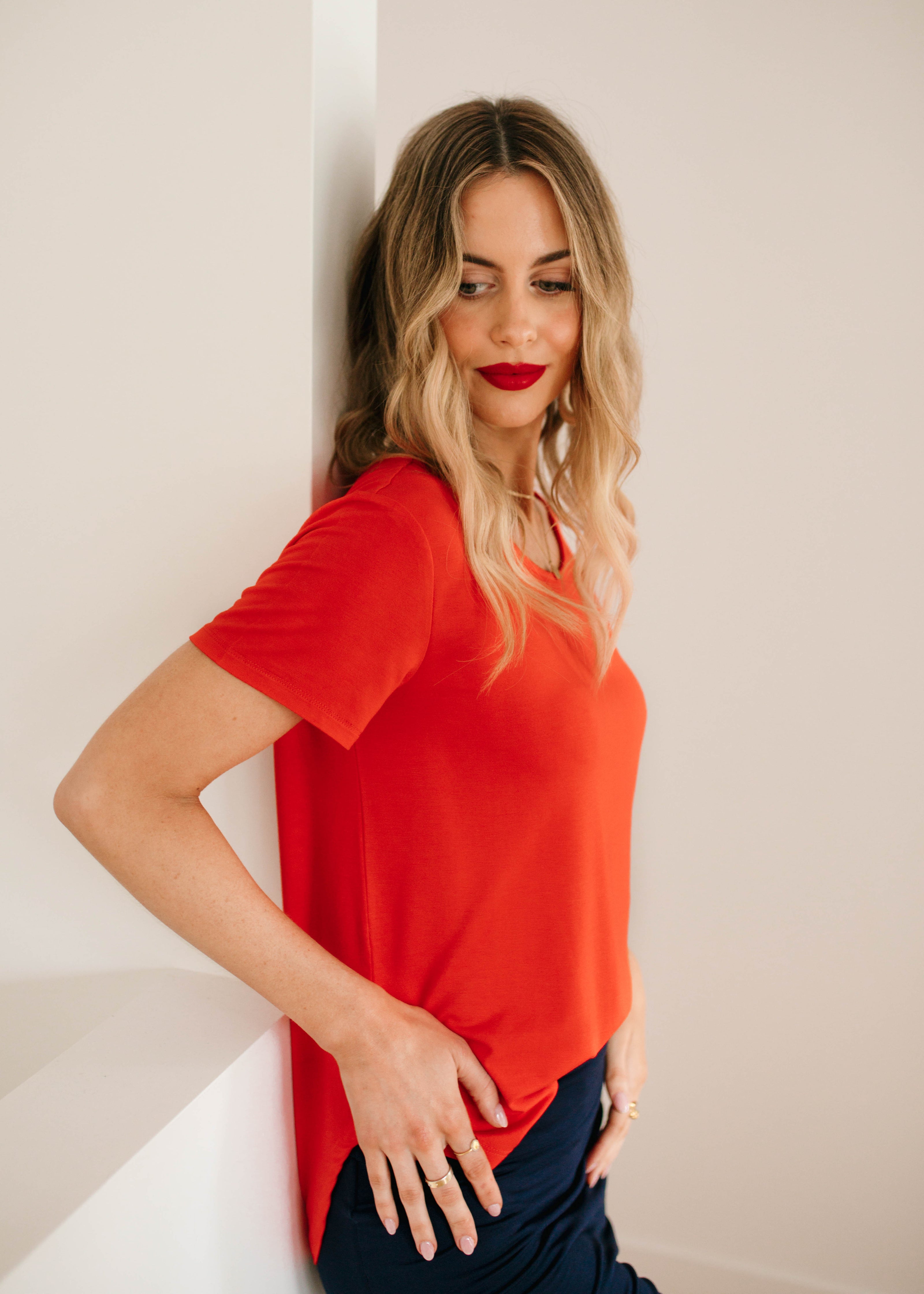 woman wearing red janis bamboo t-shirt with navy midi whitney tube skirt