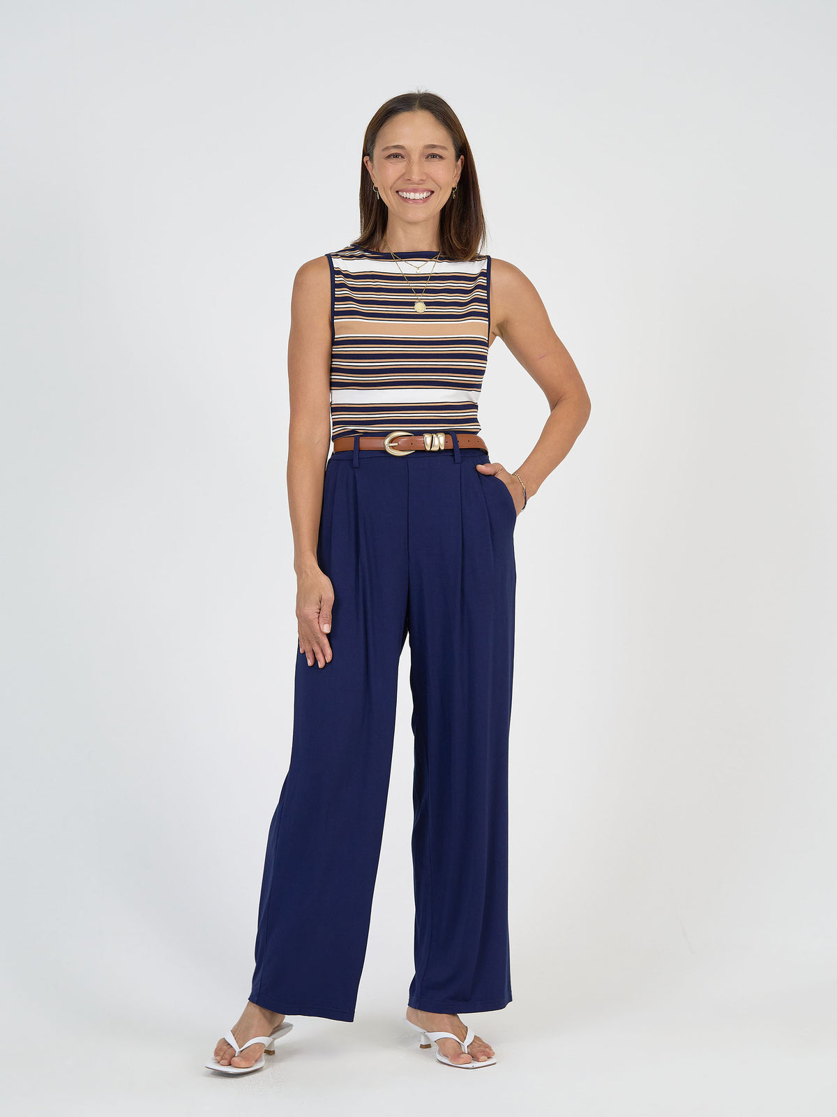 Lou Lou Australia bamboo high-waisted blue trousers with brown belt.