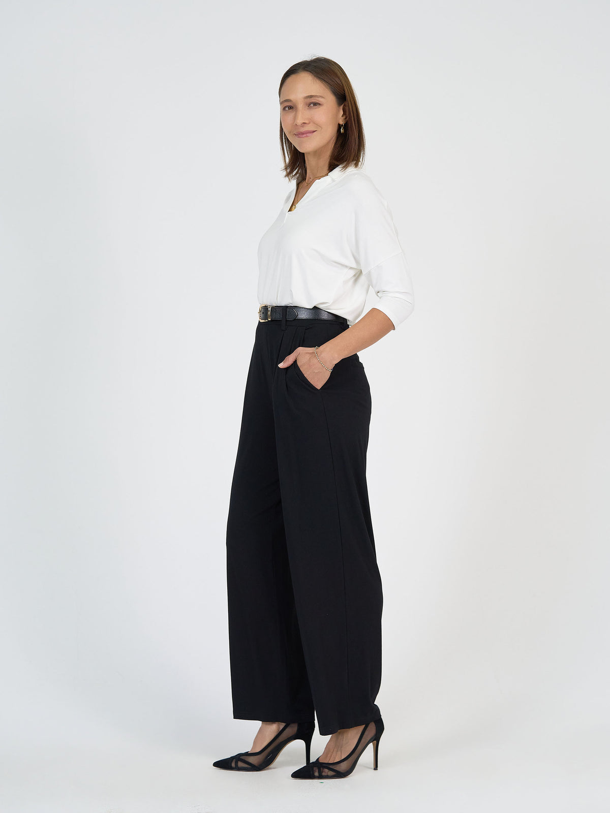 The Boardroom Set by Lou Lou Australia in bamboo; includes a white long-sleeve top and black wide leg dress pants with belt.