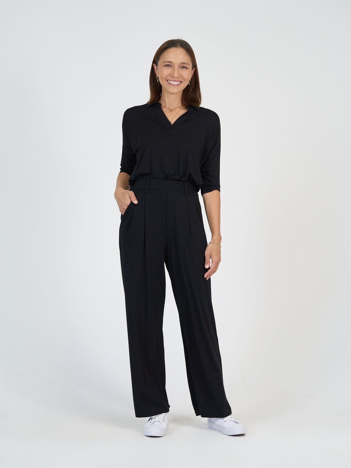 The Day Shift Set from Lou Lou Australia: black bamboo long-sleeve top and high-waisted wide leg dress pants.