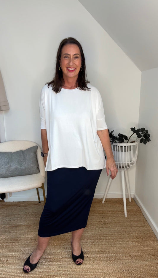 @salt.water.nomad wearing Lou Lou Australia white bamboo top and navy tube skirt
