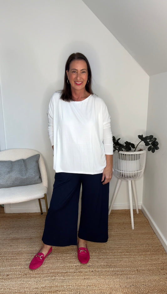 @salt.water.nomad wearing Lou Lou Australia navy bamboo culottes with white long sleeve bamboo top