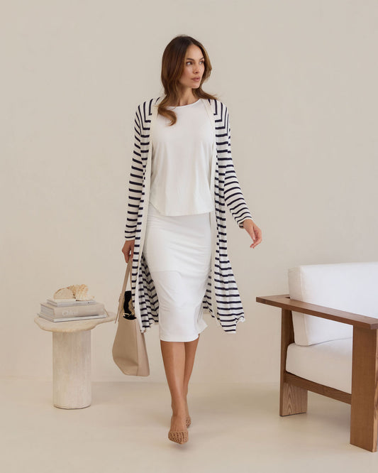 Lou Lou Australia Maxi Bamboo Whitney Tube Skirt in Cream, paired with a long black-and-white striped cardigan and white top.