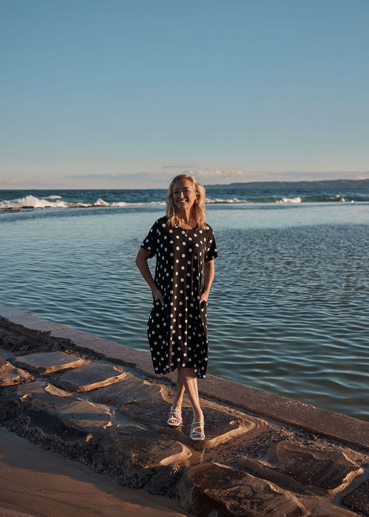 Lou Lou Australia Sade Bamboo Oversized T-Shirt Midi Dress in black and white polka dot print with hidden pockets.