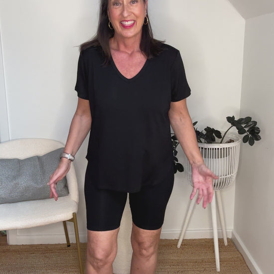 @salt.water.nomad wearing Lou Lou Australia black bamboo bike pants with black v-neck tee