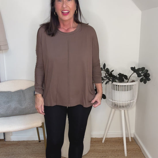 @salt.water.nomad wearing Lou Lou Australia black bamboo leggings with brown bamboo top