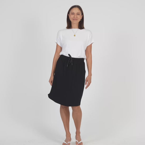 Lou Lou Australia White Bamboo T Shirt with Black Mdi length skirt with pockets 