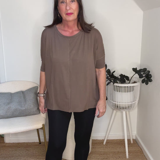 @salt.water.nomad wearing Lou Lou Australia brown bamboo top with black leggings